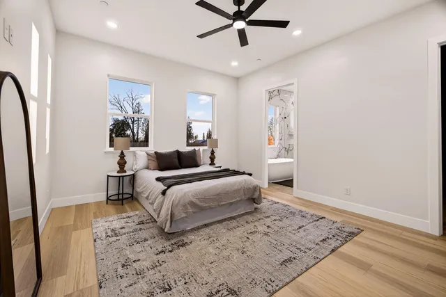 a bathroom with a double vanity sink a mirror a bathtub and shower