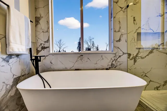 a bed sitting in a bedroom and with a book