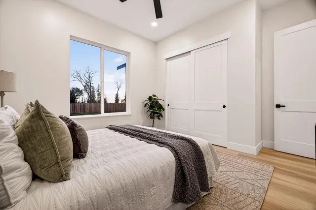 a kitchen with stainless steel appliances white cabinets and wooden floor
