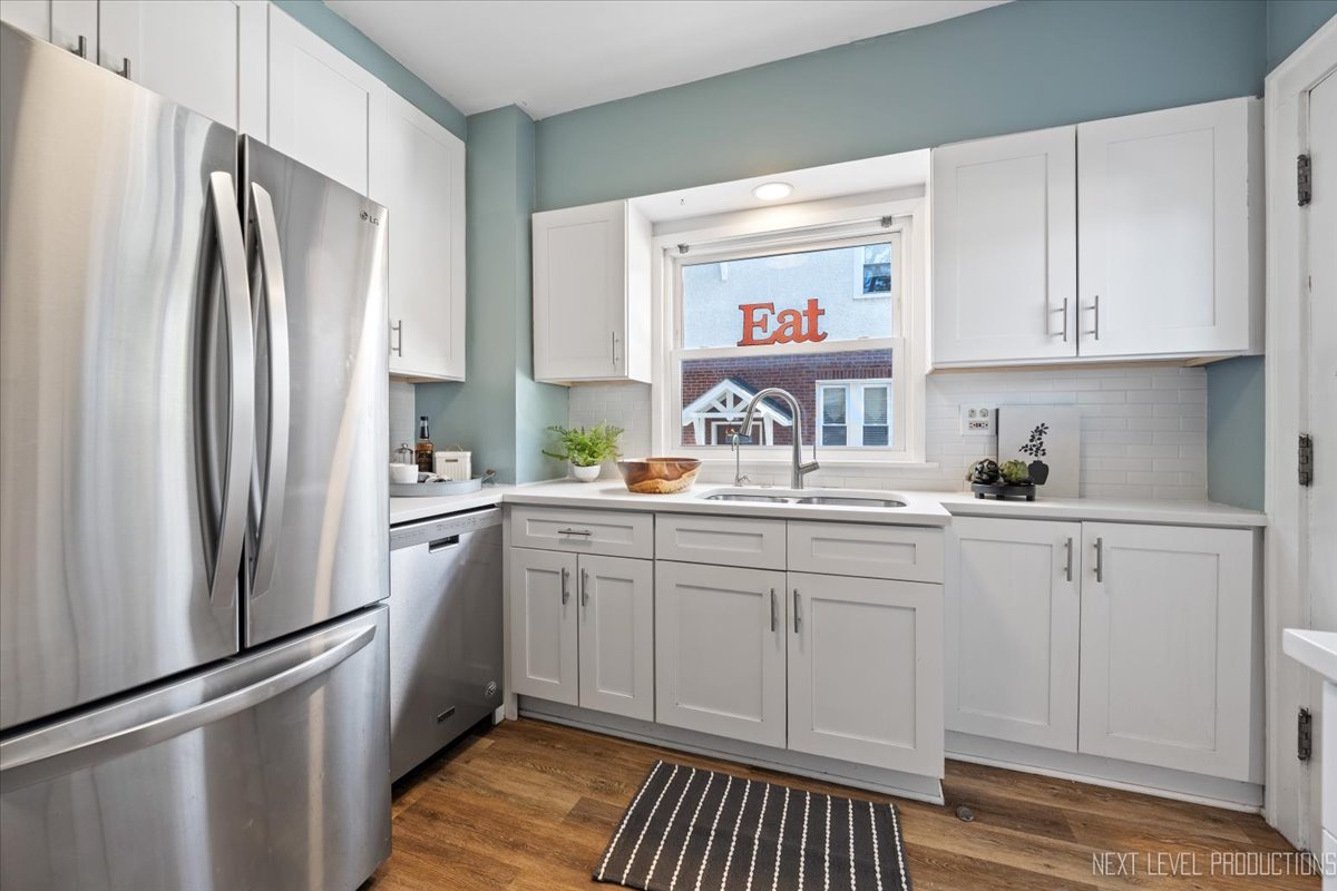 392 Herrick Road Riverside, IL 60546 - Photo 11 of 32 a kitchen with stainless steel appliances white cabinets and a refrigerator