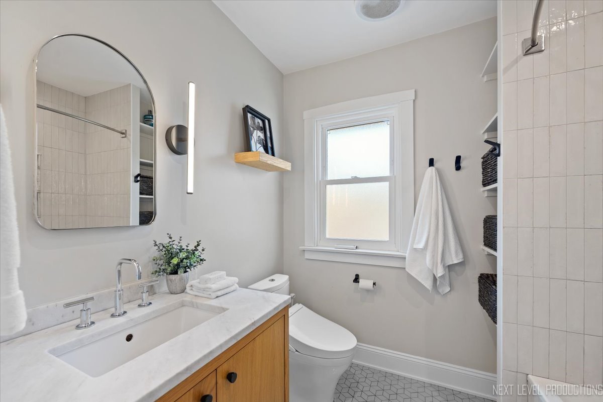 392 Herrick Road Riverside, IL 60546 - Photo 20 of 32 a bathroom with a sink vanity granite toilet and a mirror
