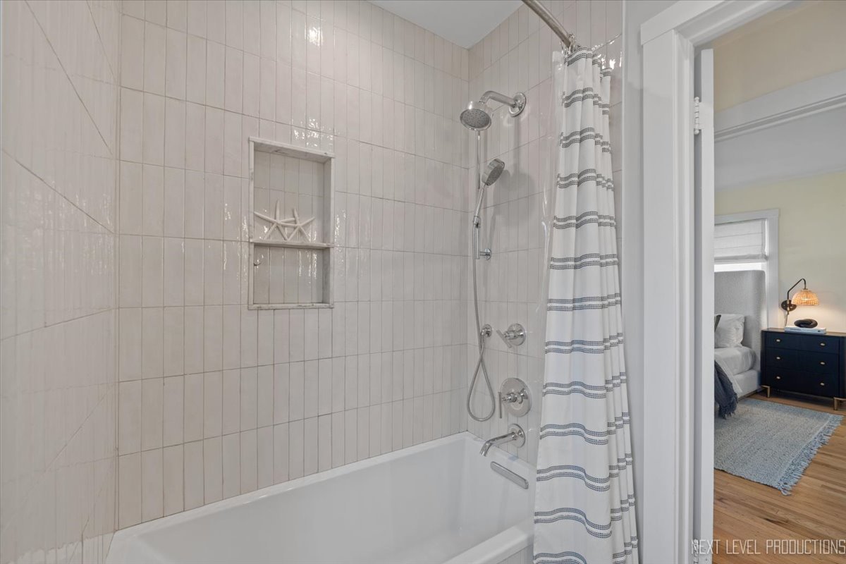 392 Herrick Road Riverside, IL 60546 - Photo 21 of 32 a bathroom with a bathtub and a shower