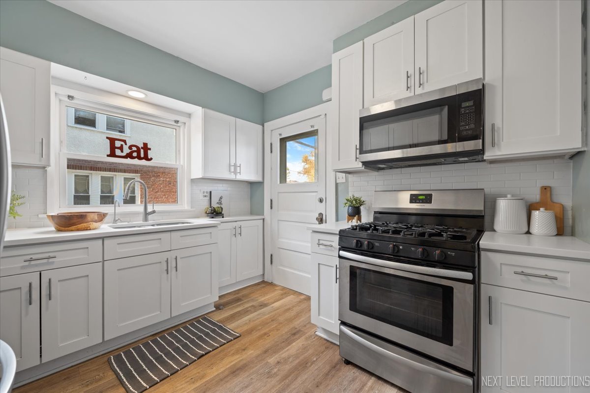 392 Herrick Road Riverside, IL 60546 - Photo 10 of 32 a kitchen with stainless steel appliances white cabinets and a stove top oven