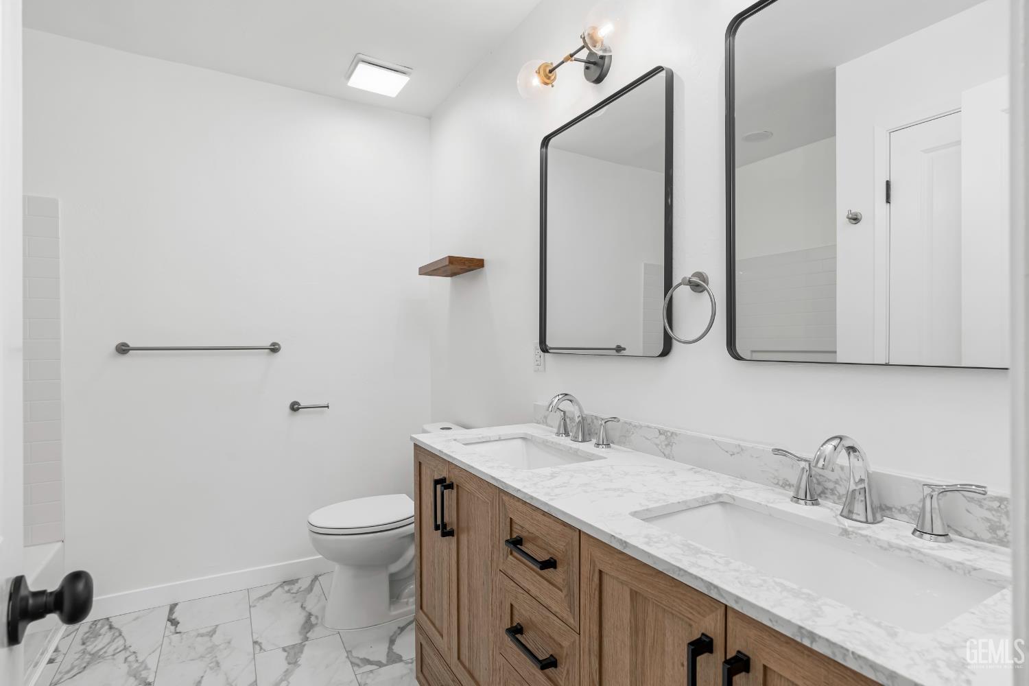 Undisclosed Address Bakersfield, CA 93305 - Photo 17 of 24 a bathroom with a granite countertop sink a toilet and a mirror