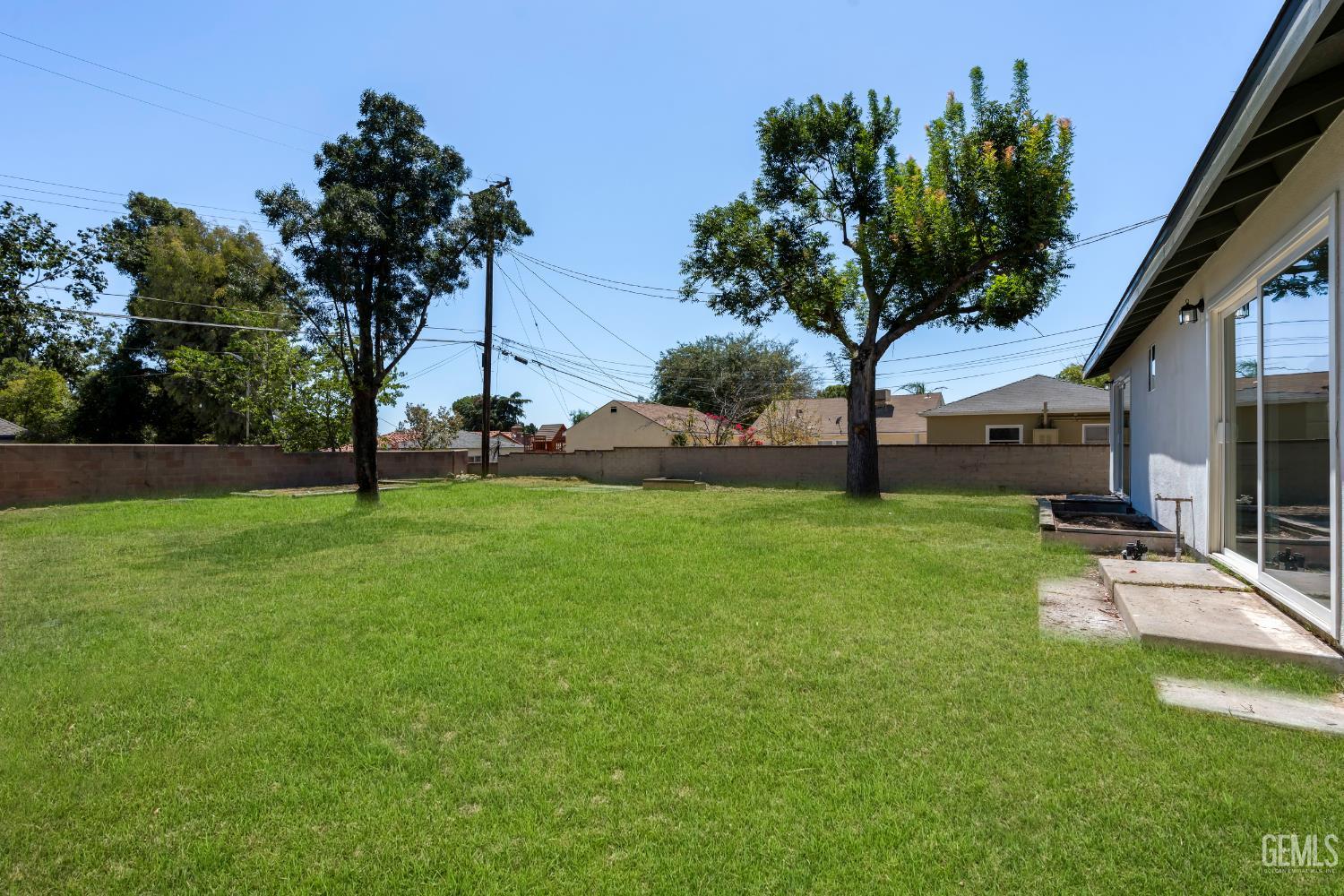 Undisclosed Address Bakersfield, CA 93305 - Photo 19 of 24 a view of a house with backyard and a tree