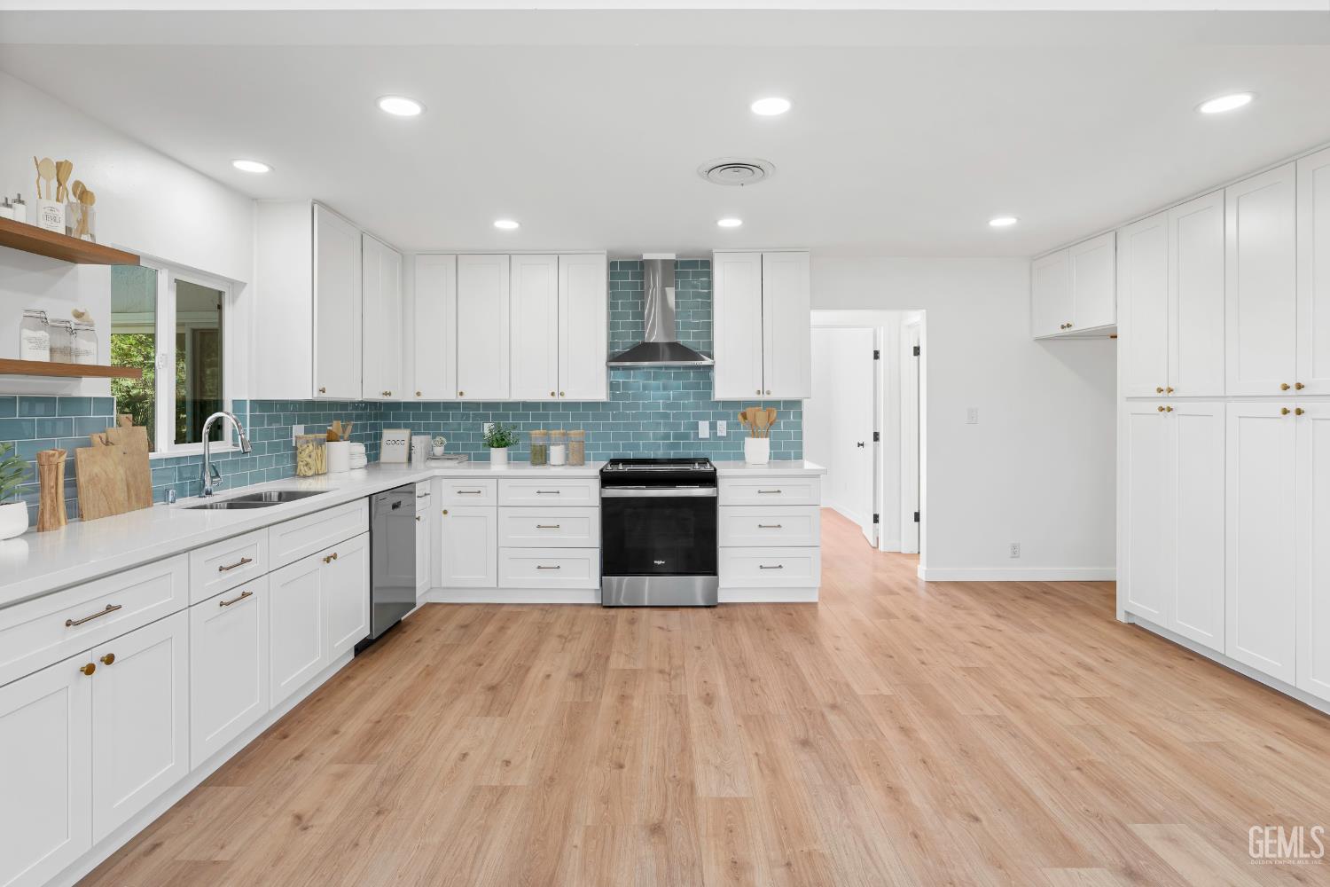 Undisclosed Address Bakersfield, CA 93305 - Photo 6 of 24 a large kitchen with granite countertop a large counter top a sink stainless steel appliances and cabinets