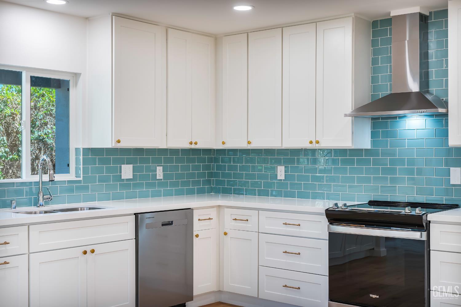 Undisclosed Address Bakersfield, CA 93305 - Photo 8 of 24 a kitchen with granite countertop white cabinets and white stainless steel appliances