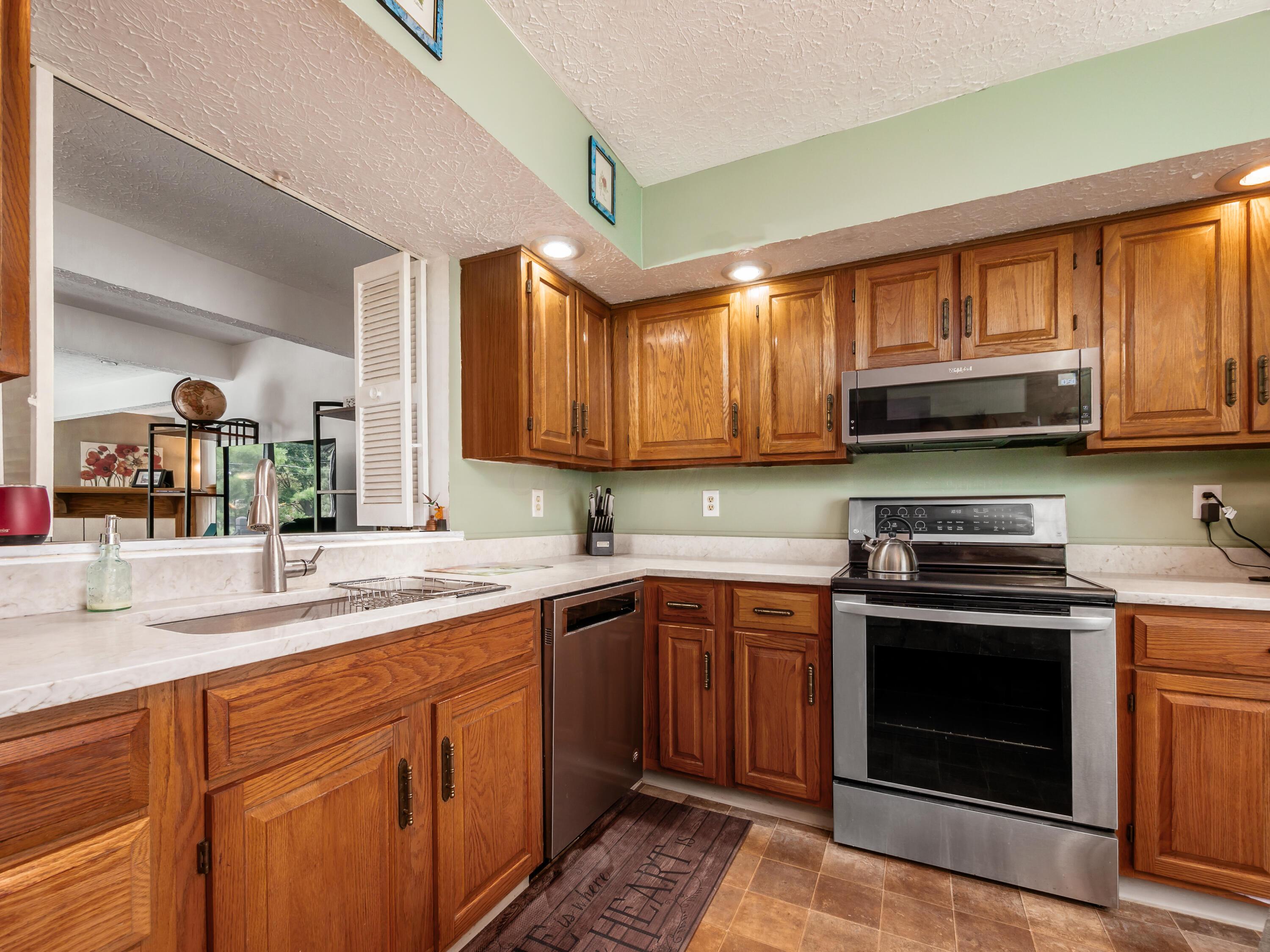7004 Avery Road Dublin, OH 43017 - Photo 6 of 31 Smooth top LG electric range, built in microwave. Pass through window to family room.