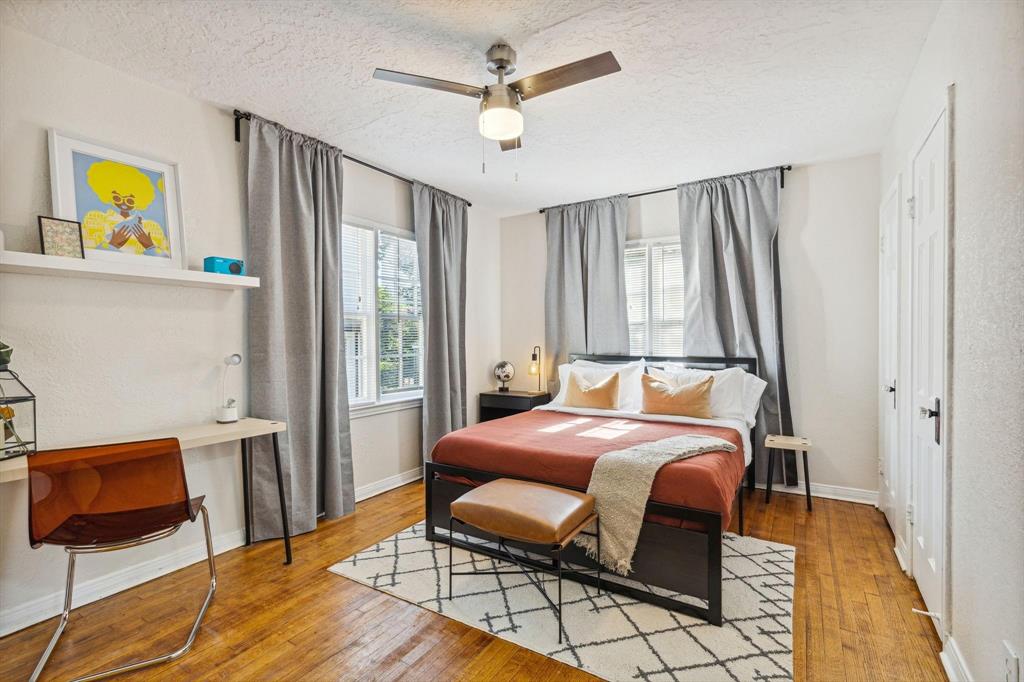 2435 West 10th Street Dallas, TX 75211 - Photo 19 of 38 a bedroom with a bed and wooden floor