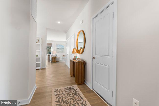 82 Ramshorn Road Inwood, WV 25428 - Photo 2 of 16 a view of a hallway with wooden floor and a bathroom