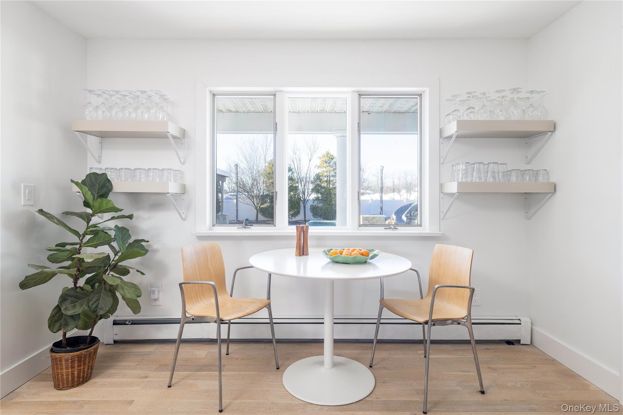 56861 Private Rd B (main) Southold, NY 11971 - Photo 12 of 34 a dining room with furniture and a potted plant