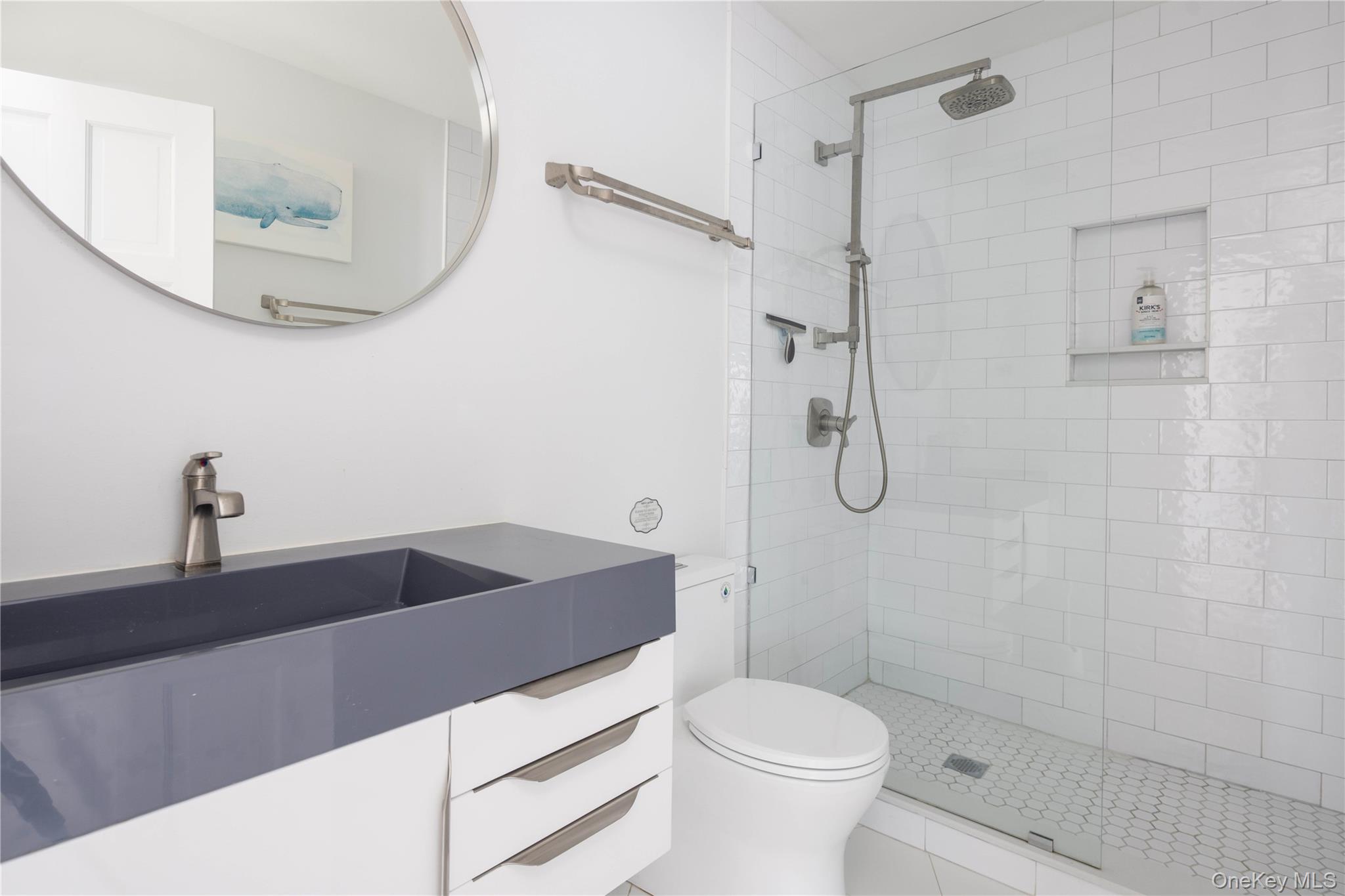 56861 Private Rd B (main) Southold, NY 11971 - Photo 14 of 35 a bathroom with a sink a toilet and shower