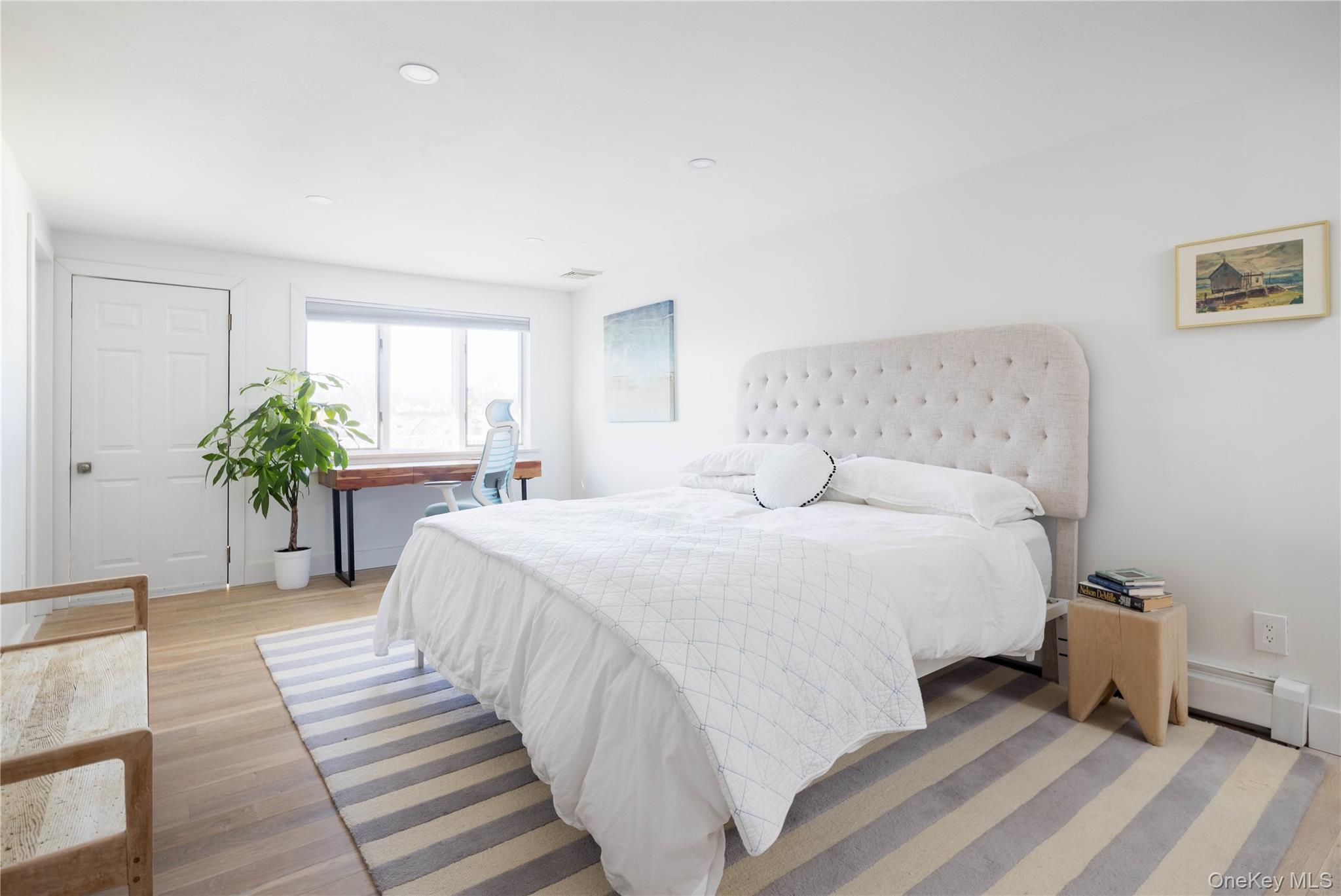 56861 Private Rd B (main) Southold, NY 11971 - Photo 17 of 34 a bedroom with a bed and a potted plant