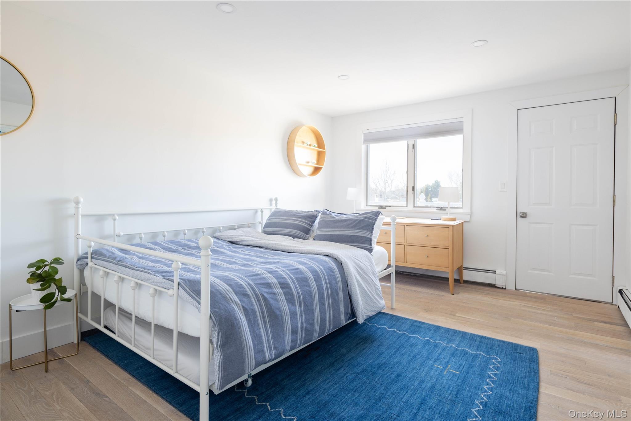 56861 Private Rd B (main) Southold, NY 11971 - Photo 19 of 34 a bed room with a bed and a chair