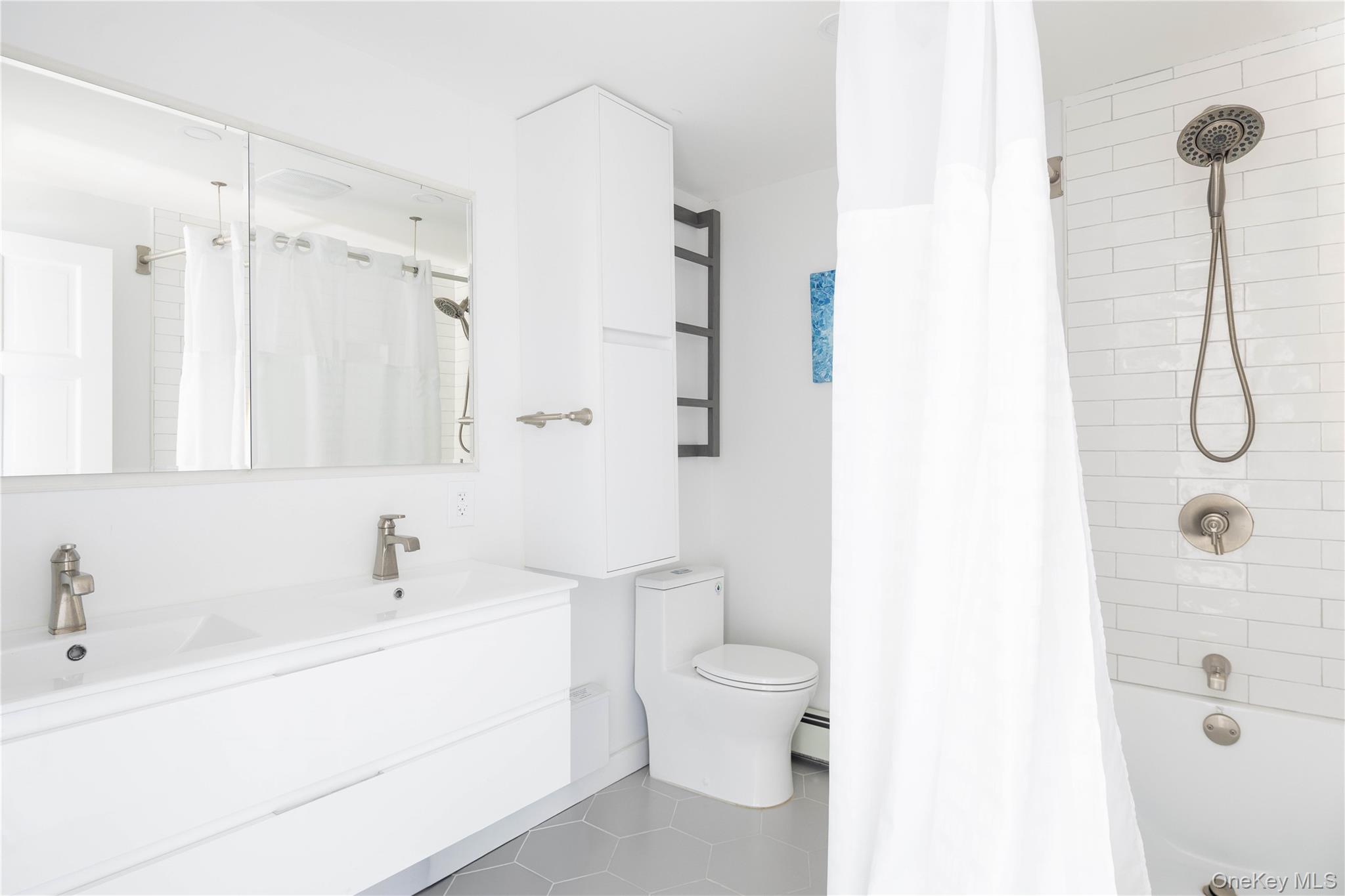 56861 Private Rd B (main) Southold, NY 11971 - Photo 21 of 34 a bathroom with a sink toilet and shower