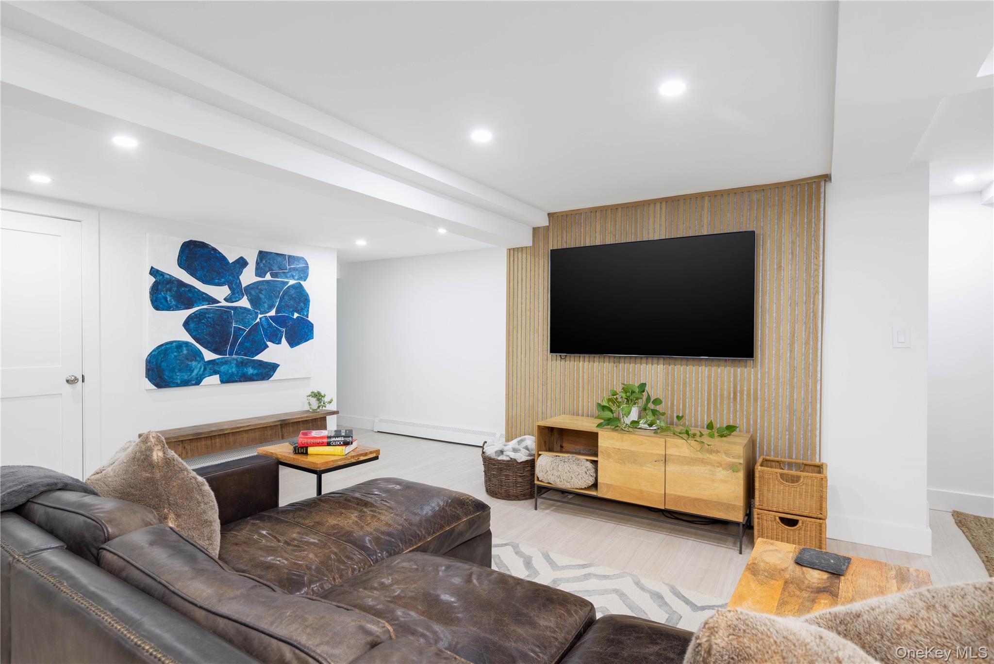 56861 Private Rd B (main) Southold, NY 11971 - Photo 22 of 34 a living room with furniture and a flat screen tv