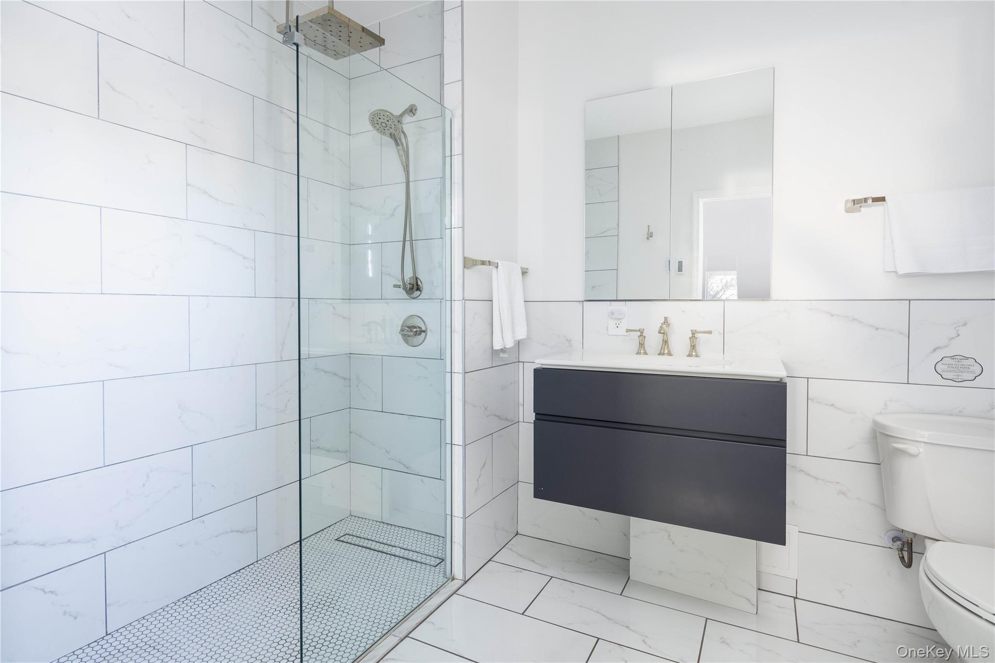 56861 Private Rd B (main) Southold, NY 11971 - Photo 24 of 34 a bathroom with a sink toilet and shower