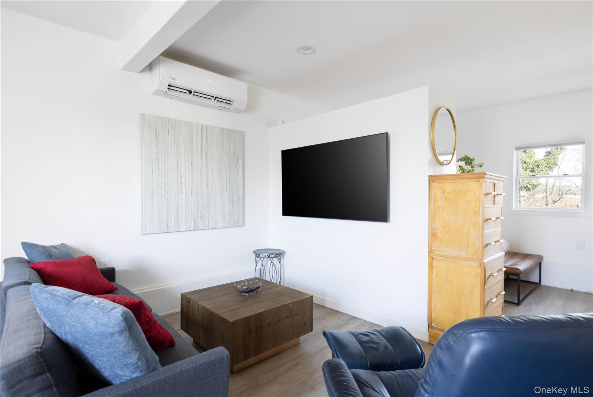 56861 Private Rd B (main) Southold, NY 11971 - Photo 25 of 34 a living room with furniture and a flat screen tv