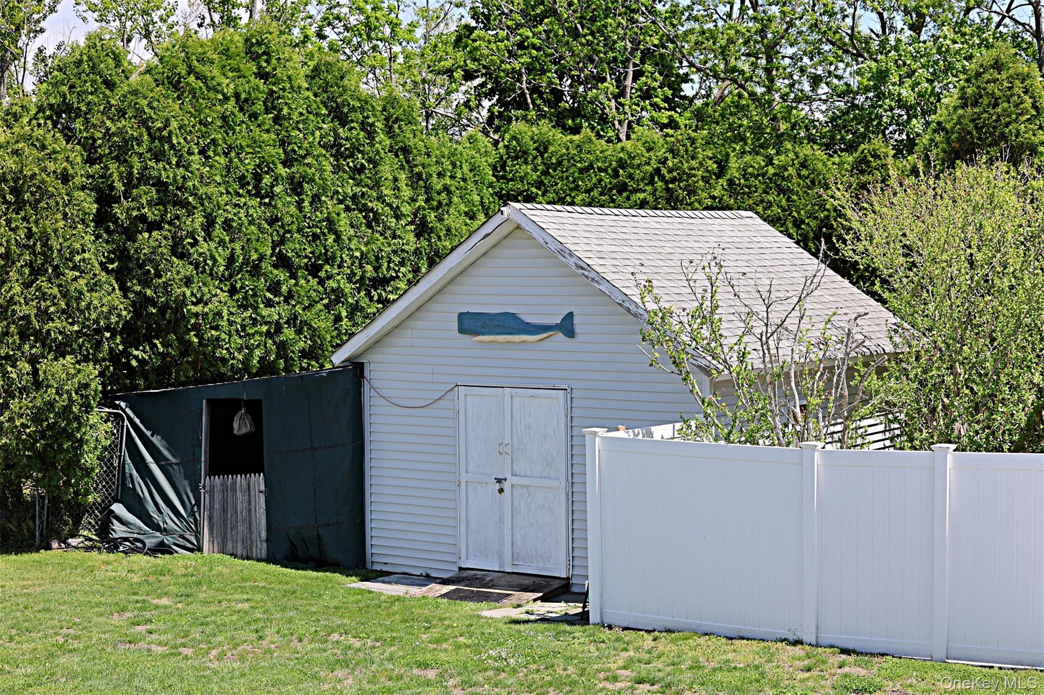 56861 Private Rd B (main) Southold, NY 11971 - Photo 27 of 34 a view of a house with a yard and wooden fence