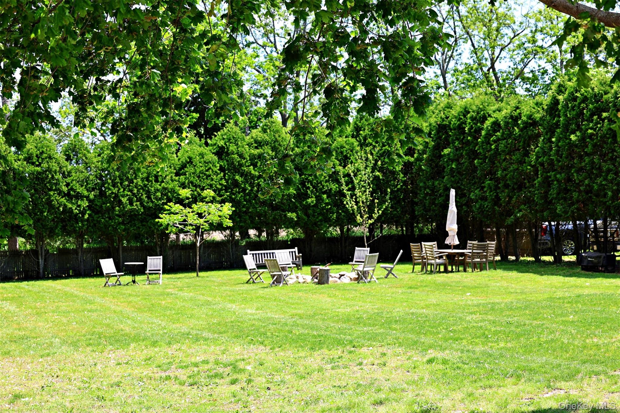 56861 Private Rd B (main) Southold, NY 11971 - Photo 29 of 34 View of side yard featuring a fire pit, grill and recreation area