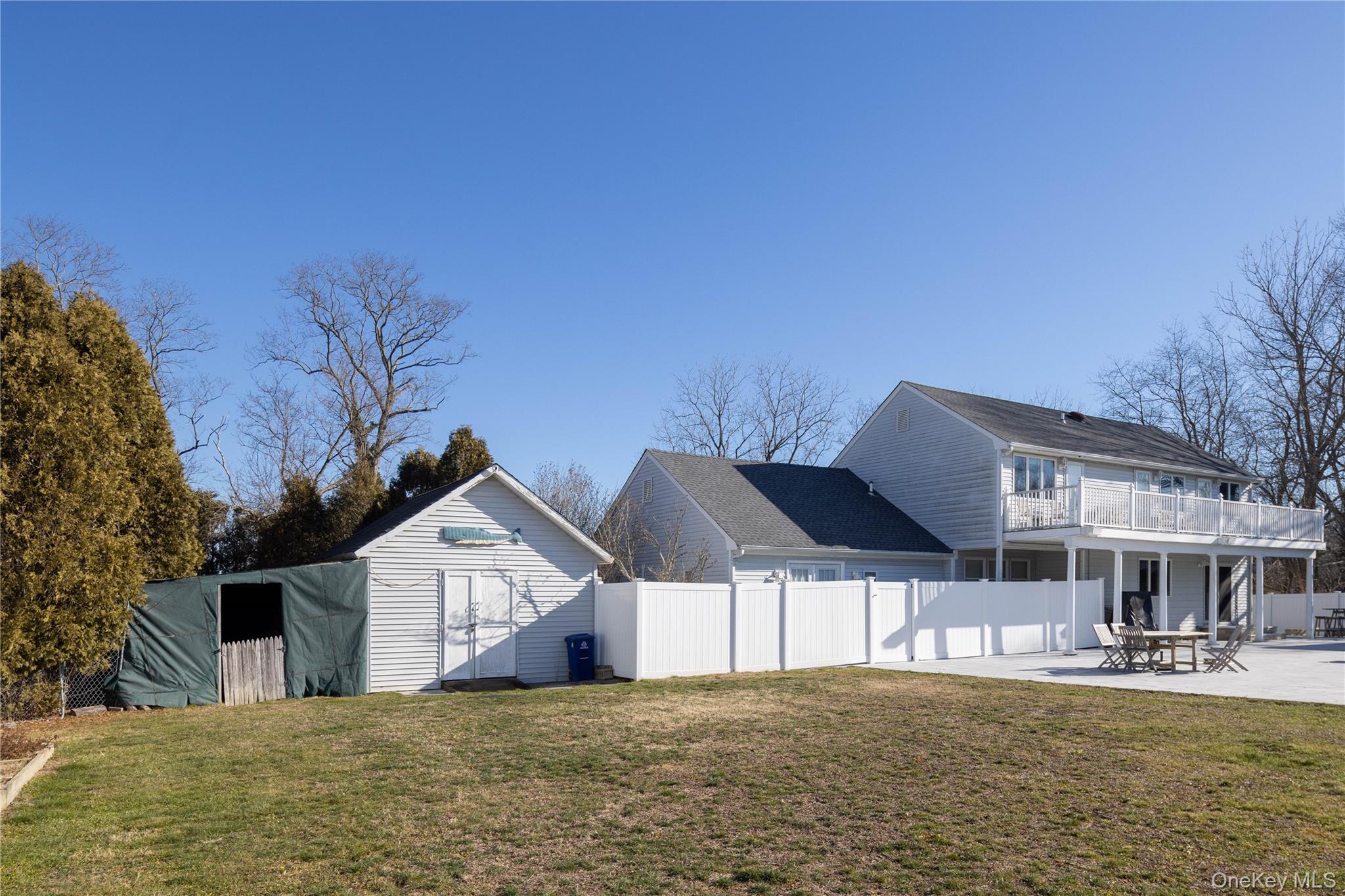 56861 Private Rd B (main) Southold, NY 11971 - Photo 29 of 35 a view of a house with large trees and a big yard