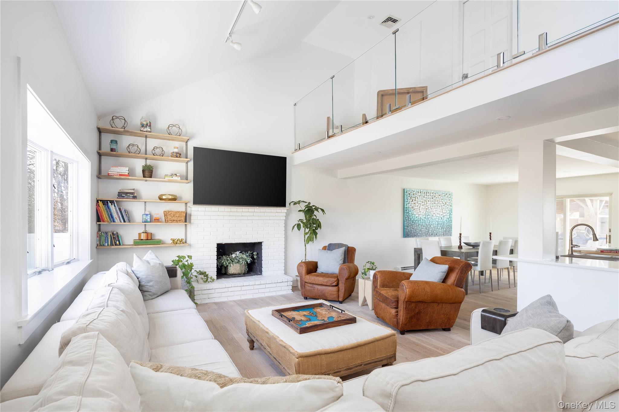 56861 Private Rd B (main) Southold, NY 11971 - Photo 8 of 34 a living room with furniture fireplace and a flat screen tv