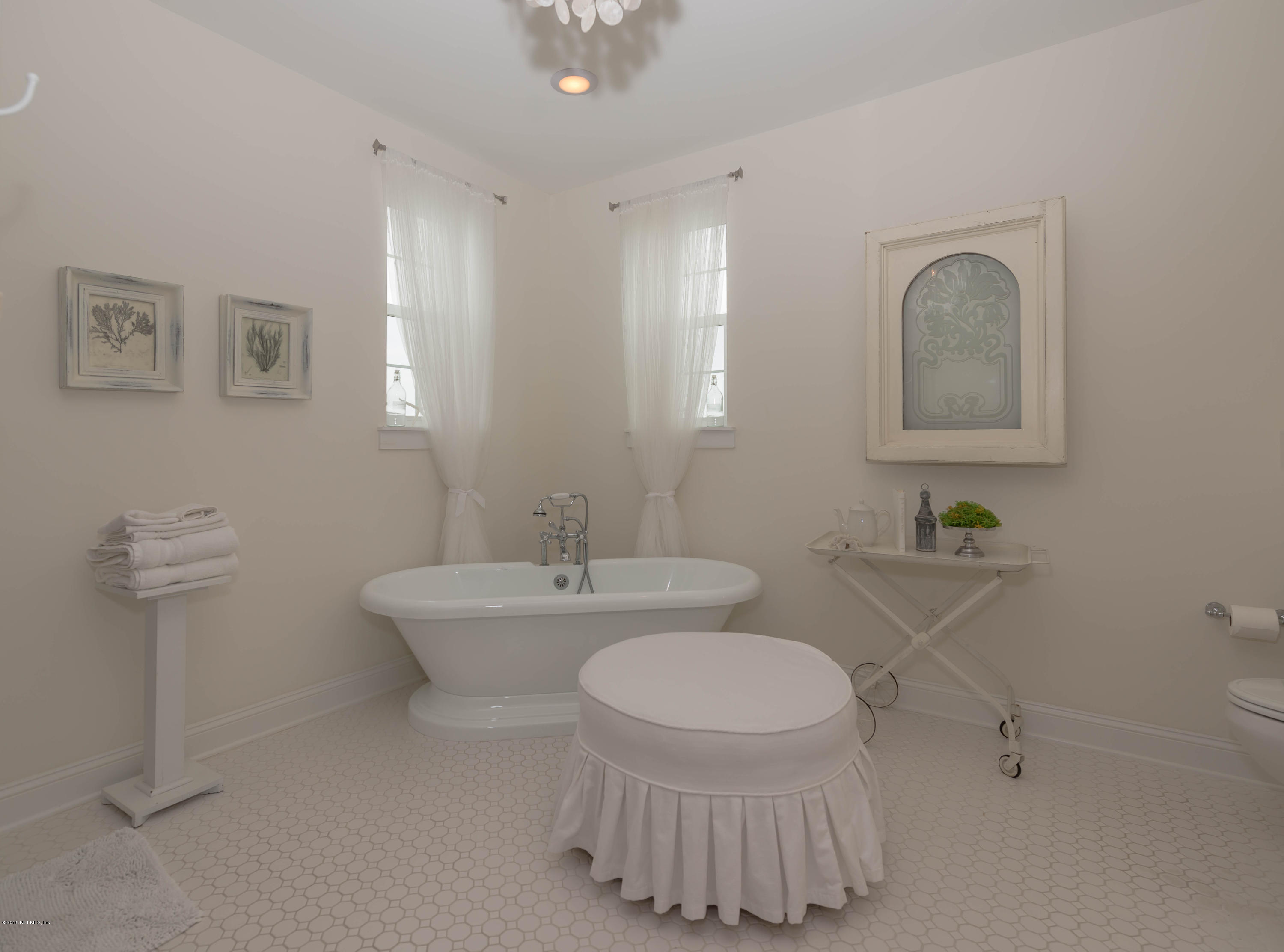 10 12th Street St. Augustine Beach, FL 32080 - Photo 20 of 45 a bathroom with a sink a toilet and mirror