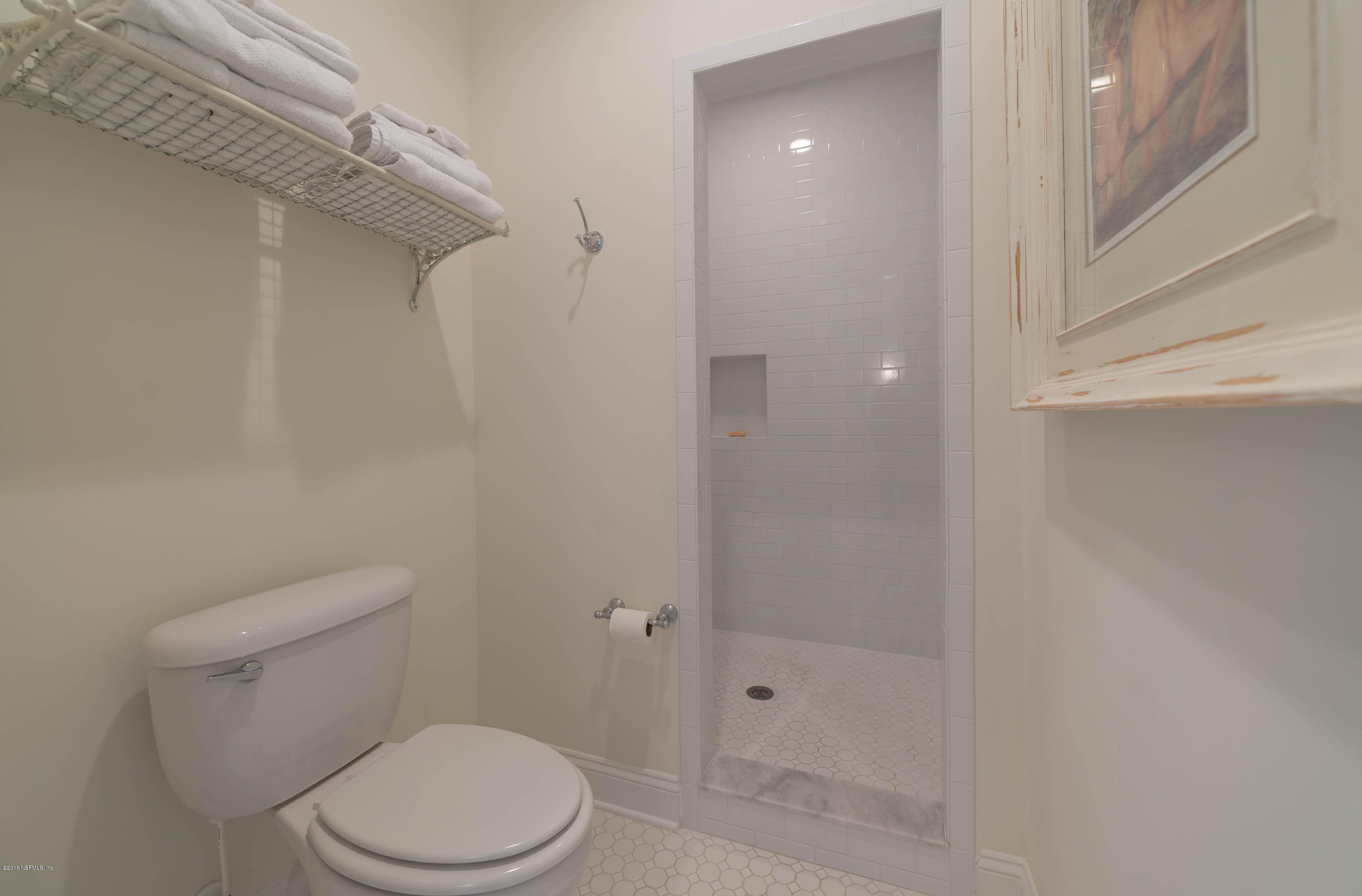 10 12th Street St. Augustine Beach, FL 32080 - Photo 34 of 45 a white toilet sitting next to a bathroom sink