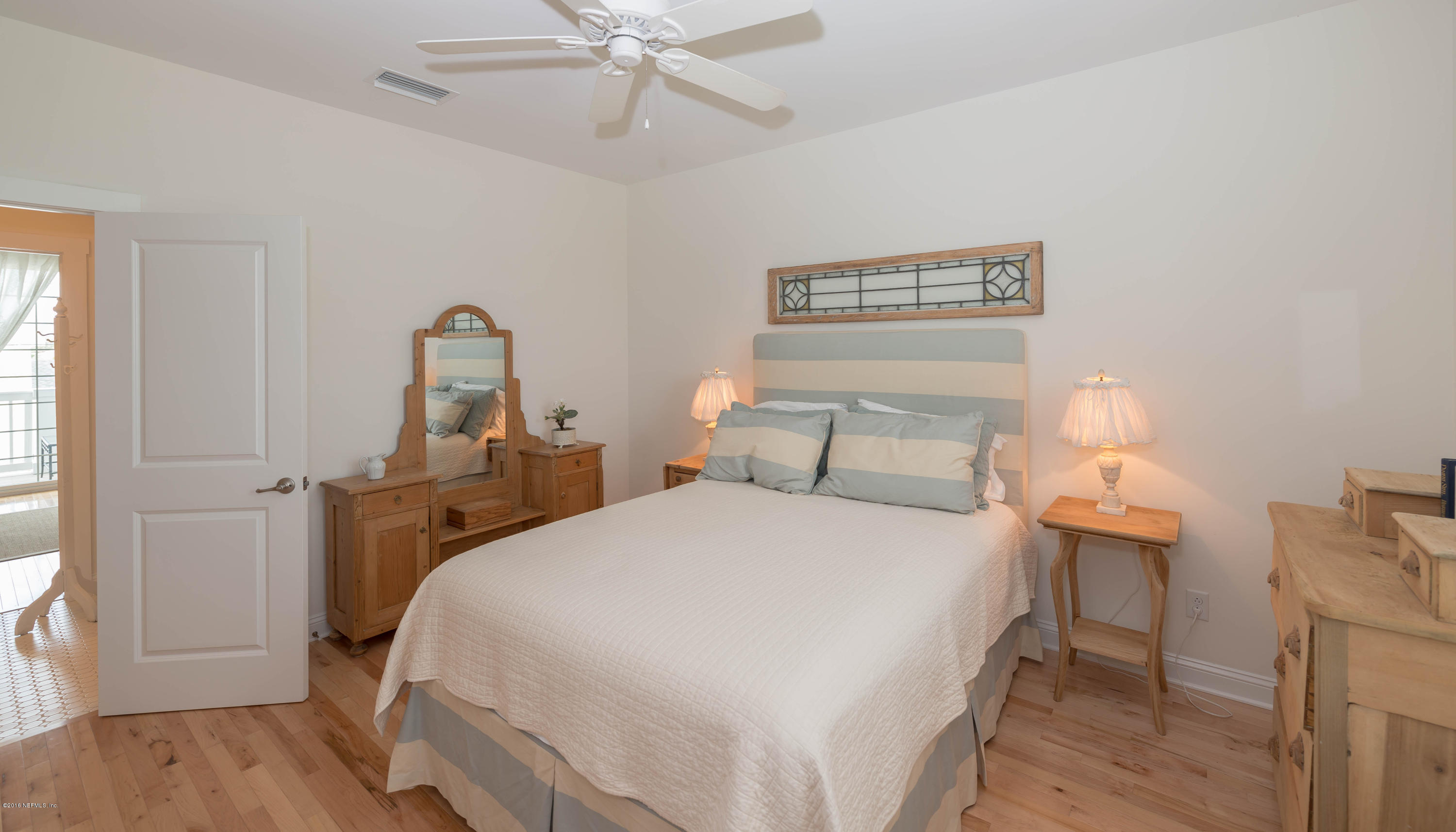 10 12th Street St. Augustine Beach, FL 32080 - Photo 36 of 45 a bedroom with a bed and wooden floor