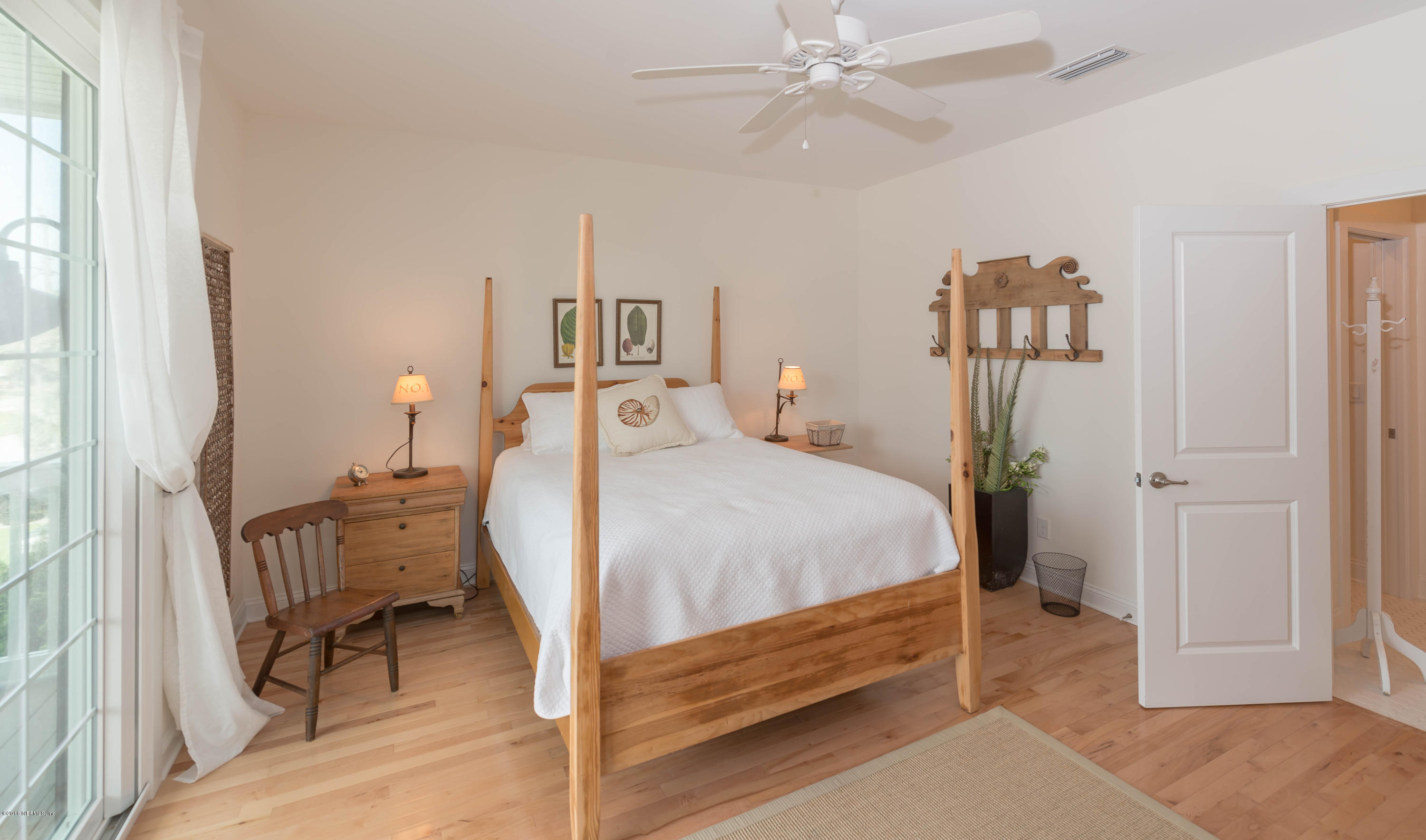 10 12th Street St. Augustine Beach, FL 32080 - Photo 40 of 45 a bedroom with a bed and a chandelier