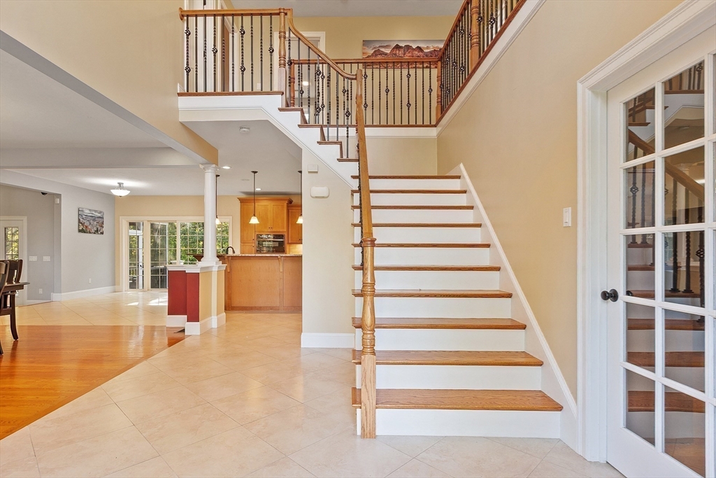9 Winter Hill Road Lunenburg, MA 01462 - Photo 26 of 42 a view of staircase with lots of frames on wall and a dining table