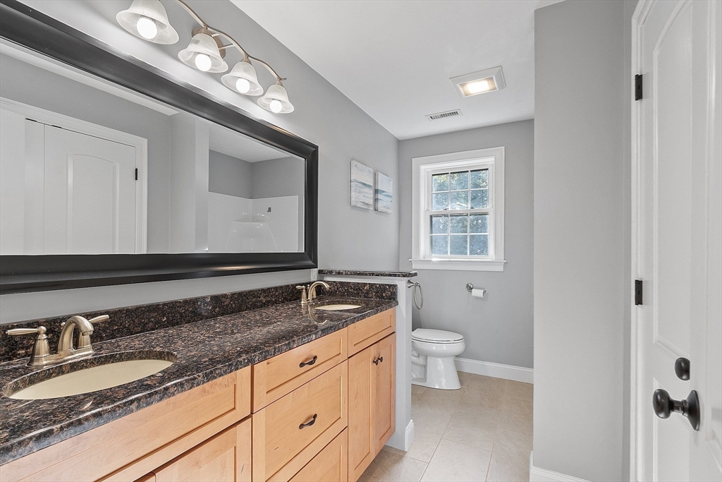 9 Winter Hill Road Lunenburg, MA 01462 - Photo 39 of 42 a bathroom with a granite countertop toilet sink and mirror