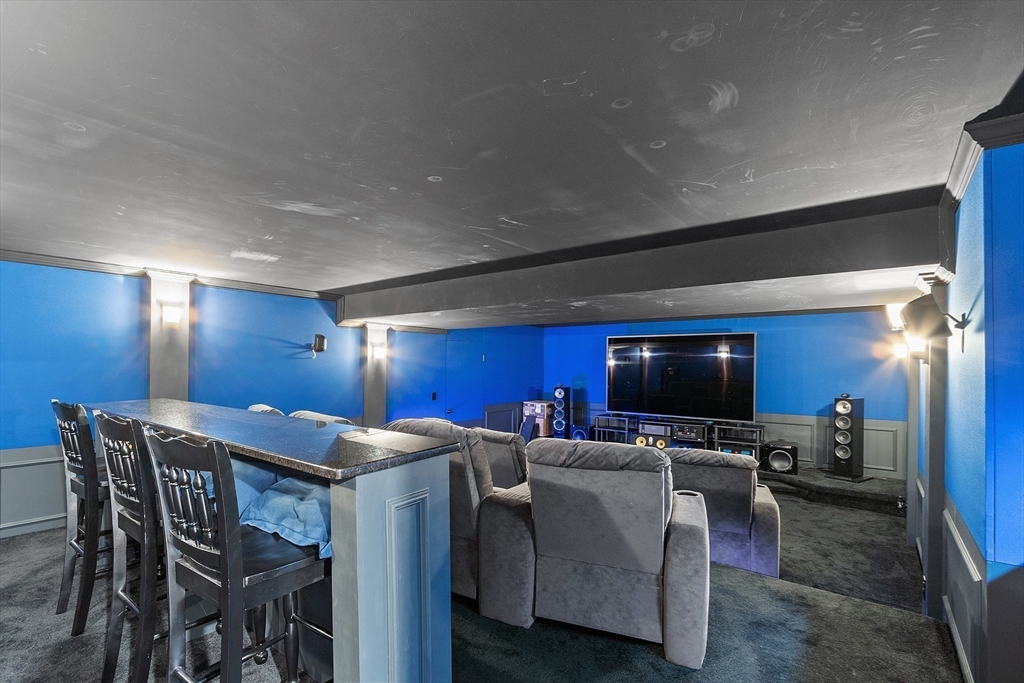 9 Winter Hill Road Lunenburg, MA 01462 - Photo 40 of 42 a kitchen with stainless steel appliances kitchen island granite countertop a table chairs microwave and sink