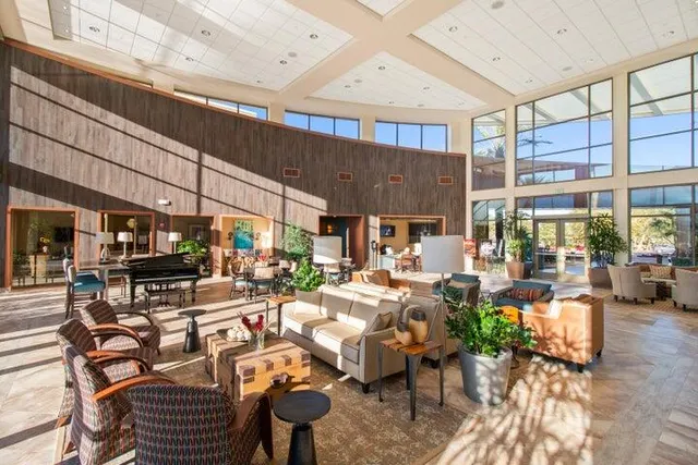a view of a livingroom with wooden floor and furniture