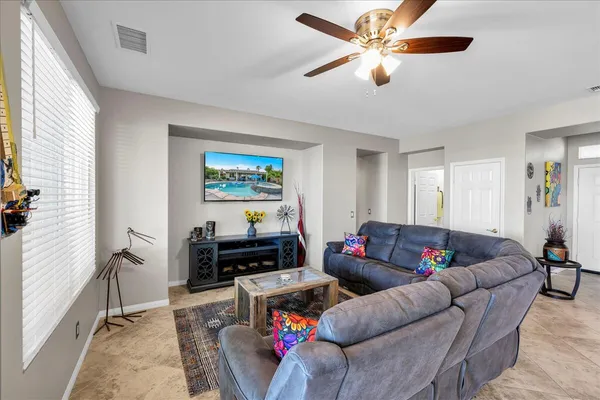 a front view of a house with a yard and potted plants