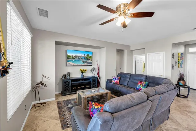 a front view of a house with a yard and potted plants