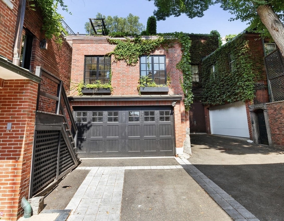 20 Chestnut Street, Unit 1 Boston, MA 02108 - Photo 10 of 26 a front view of a house with a yard and garage