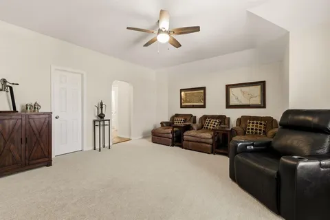 a living room with furniture a ceiling fan and a couch