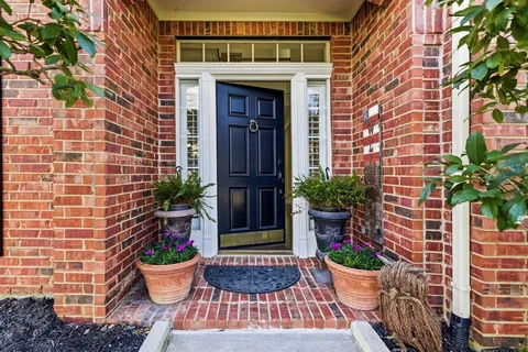 a view of of entryway of the house with potted plants