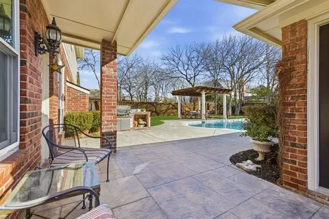 a view of a chair and tables in the patio