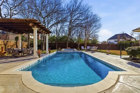 a view of a swimming pool with sitting area
