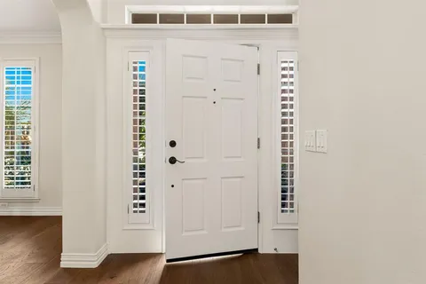 an entryway with wooden floor