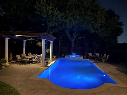 a view of a swimming pool with chairs in patio