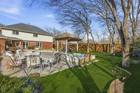 a view of a house with backyard porch and sitting area