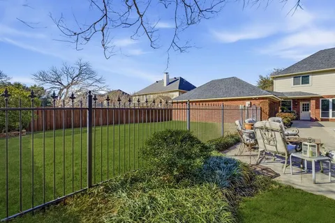 a view of a garden with a bench in patio