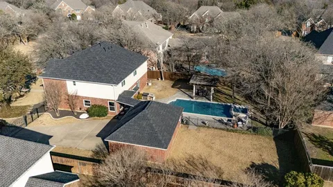 an aerial view of a house with outdoor space