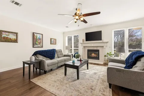 a living room with furniture a fireplace and a flat screen tv