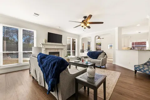 a living room with fireplace furniture and a flat screen tv