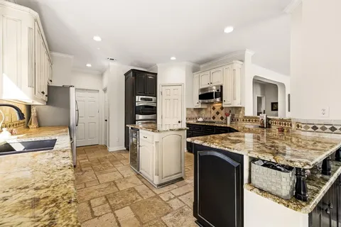 a kitchen with a stove a sink and a refrigerator