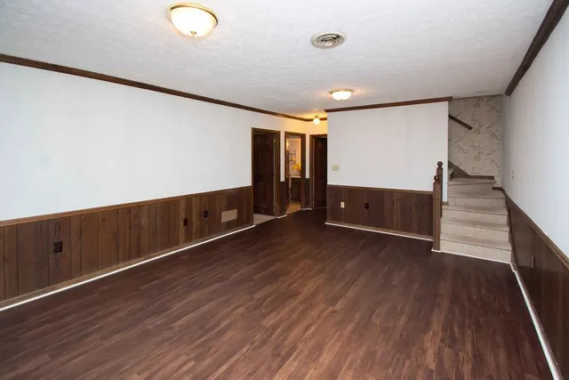 a kitchen with granite countertop stainless steel appliances a refrigerator a stove top oven and a refrigerator